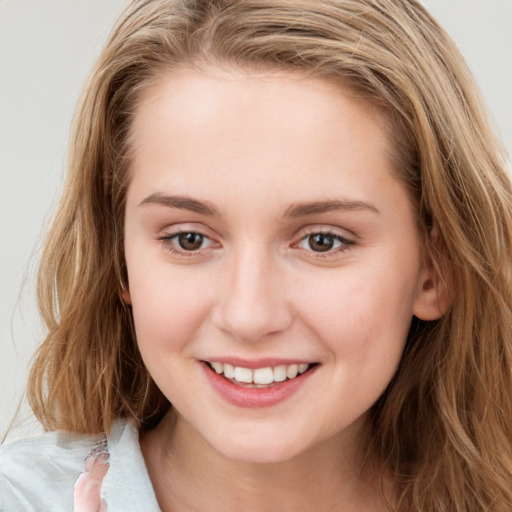 Joyful white young-adult female with long  brown hair and blue eyes