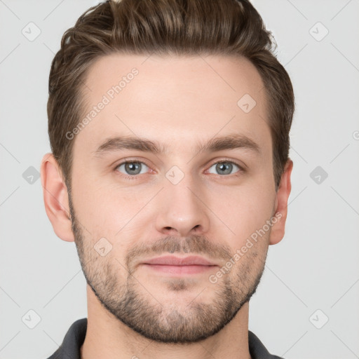 Joyful white young-adult male with short  brown hair and grey eyes