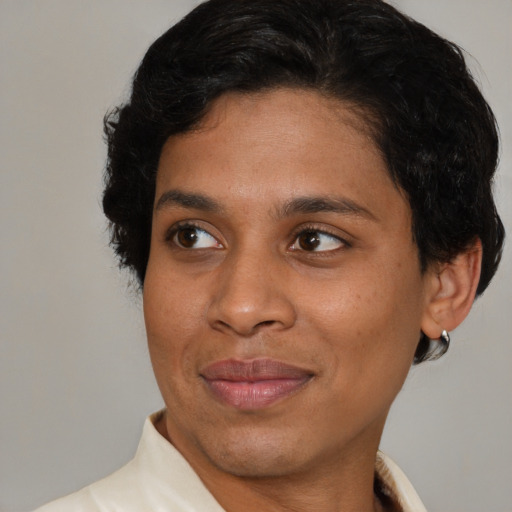 Joyful black adult female with short  brown hair and brown eyes