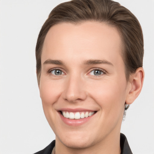 Joyful white young-adult female with short  brown hair and grey eyes