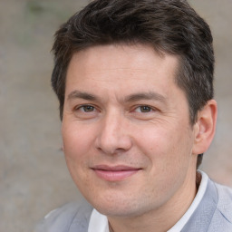 Joyful white adult male with short  brown hair and brown eyes