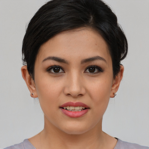 Joyful asian young-adult female with short  brown hair and brown eyes