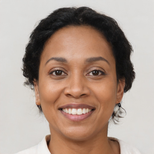 Joyful latino adult female with medium  brown hair and brown eyes