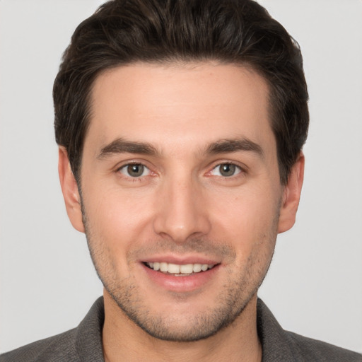 Joyful white young-adult male with short  brown hair and brown eyes