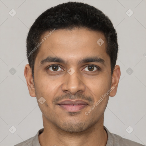 Joyful latino young-adult male with short  brown hair and brown eyes