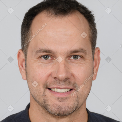 Joyful white adult male with short  brown hair and brown eyes