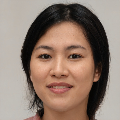 Joyful asian young-adult female with medium  brown hair and brown eyes