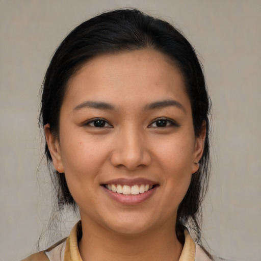 Joyful asian young-adult female with medium  brown hair and brown eyes