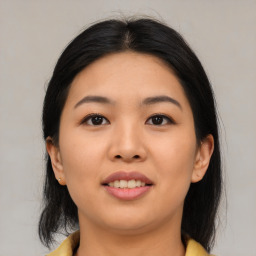 Joyful asian young-adult female with medium  black hair and brown eyes