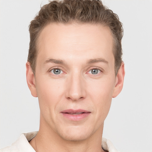 Joyful white adult male with short  brown hair and grey eyes