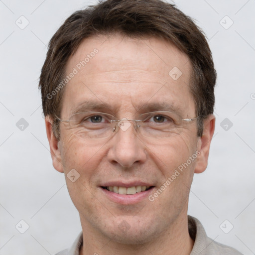 Joyful white adult male with short  brown hair and grey eyes