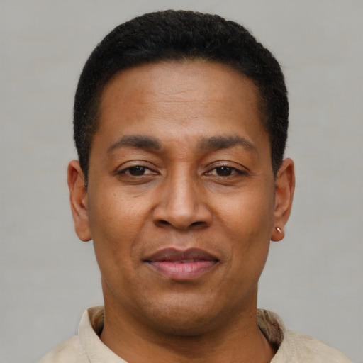 Joyful latino young-adult male with short  brown hair and brown eyes