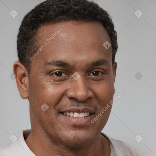 Joyful latino adult male with short  brown hair and brown eyes