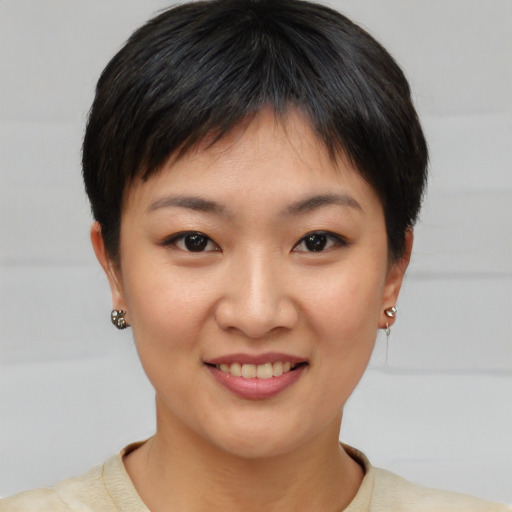Joyful asian young-adult female with short  brown hair and brown eyes