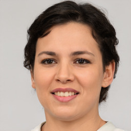 Joyful white young-adult female with medium  brown hair and brown eyes