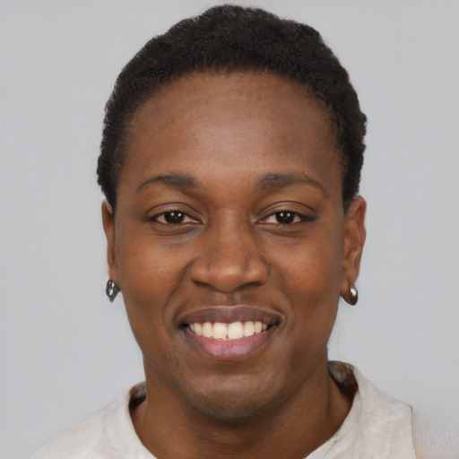 Joyful black young-adult female with short  black hair and brown eyes