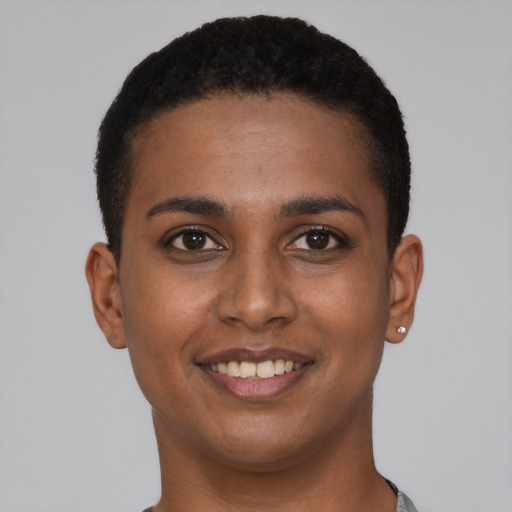 Joyful black young-adult female with short  black hair and brown eyes