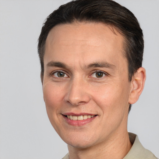 Joyful white adult male with short  brown hair and brown eyes