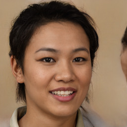 Joyful asian young-adult female with medium  brown hair and brown eyes