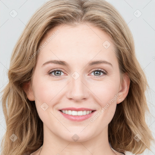 Joyful white young-adult female with long  brown hair and blue eyes