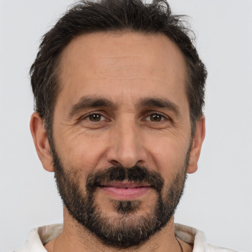 Joyful white adult male with short  brown hair and brown eyes