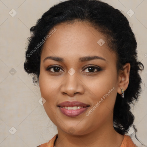 Joyful black young-adult female with long  brown hair and brown eyes