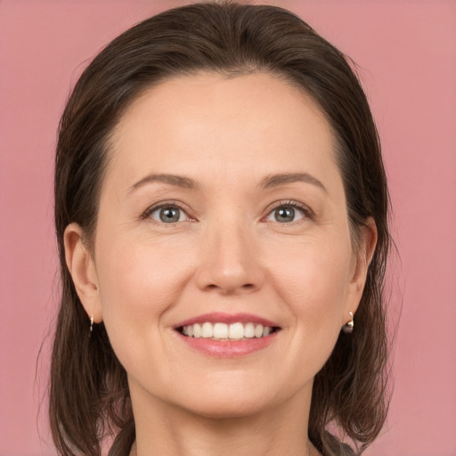 Joyful white young-adult female with medium  brown hair and brown eyes