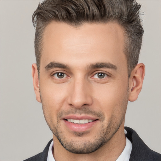 Joyful white young-adult male with short  brown hair and brown eyes