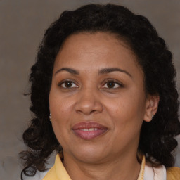 Joyful black adult female with medium  brown hair and brown eyes