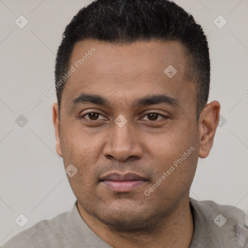 Joyful latino young-adult male with short  black hair and brown eyes