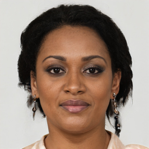 Joyful black adult female with short  black hair and brown eyes