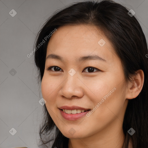 Joyful asian young-adult female with long  brown hair and brown eyes