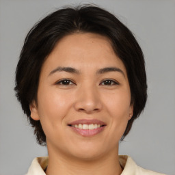 Joyful asian young-adult female with medium  brown hair and brown eyes