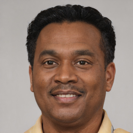 Joyful latino adult male with short  black hair and brown eyes