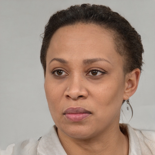 Joyful black adult female with short  brown hair and brown eyes