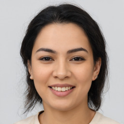 Joyful asian young-adult female with medium  brown hair and brown eyes