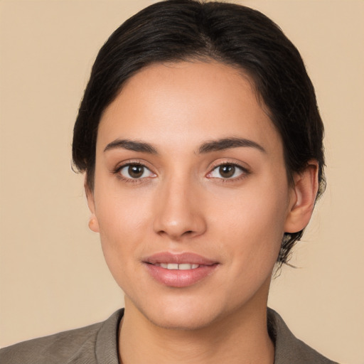 Joyful white young-adult female with short  black hair and brown eyes