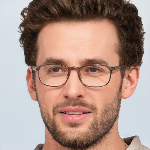 Joyful white young-adult male with short  brown hair and blue eyes