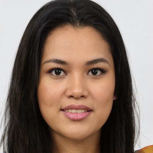Joyful asian young-adult female with long  brown hair and brown eyes