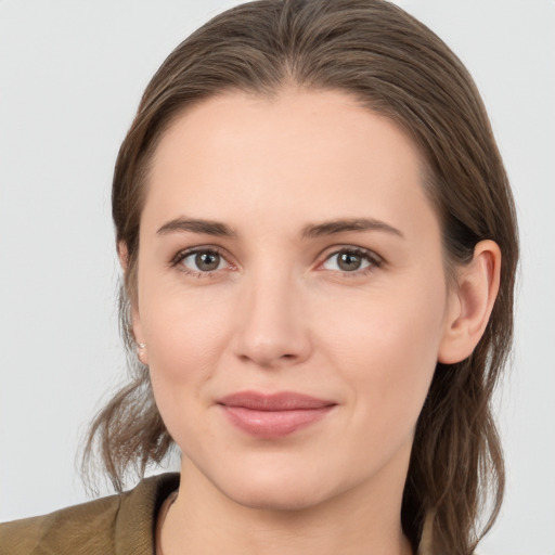 Joyful white young-adult female with medium  brown hair and grey eyes