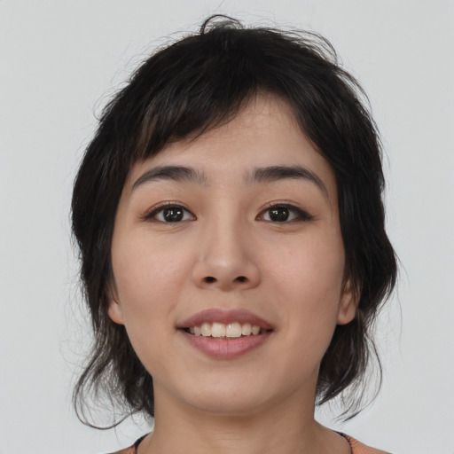 Joyful asian young-adult female with medium  black hair and brown eyes