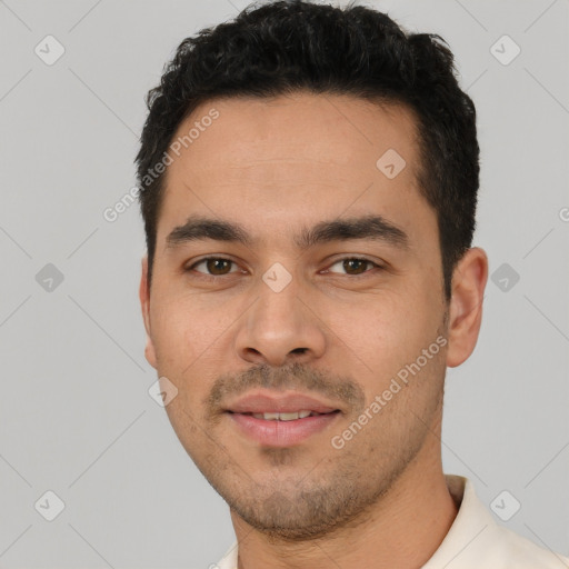 Joyful white young-adult male with short  black hair and brown eyes