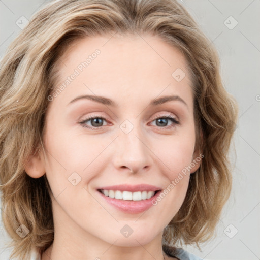 Joyful white young-adult female with medium  brown hair and blue eyes