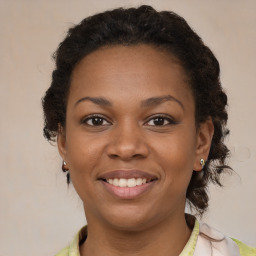 Joyful black young-adult female with medium  brown hair and brown eyes