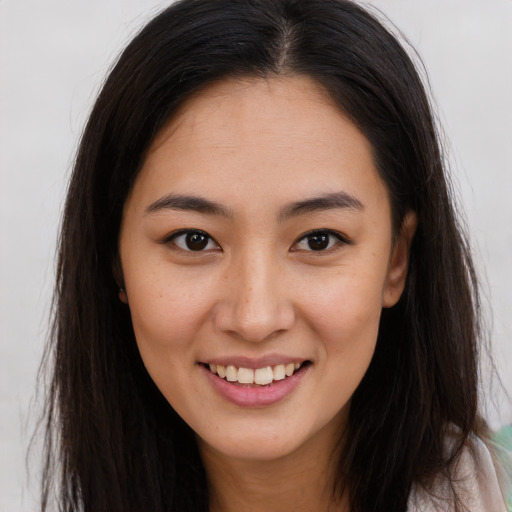 Joyful asian young-adult female with long  brown hair and brown eyes