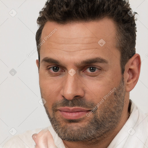 Joyful white adult male with short  brown hair and brown eyes