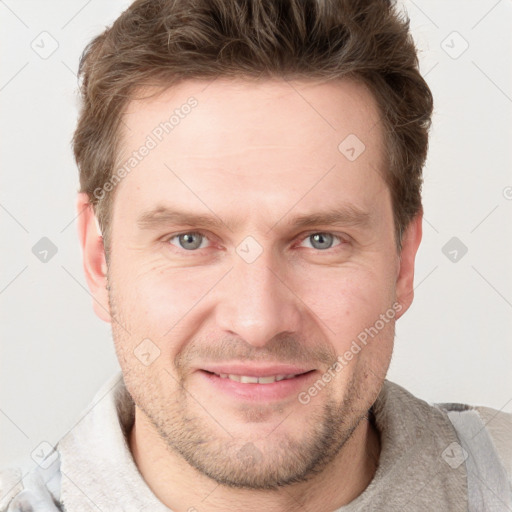 Joyful white adult male with short  brown hair and grey eyes