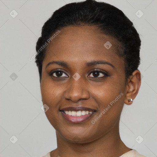 Joyful black young-adult female with short  black hair and brown eyes