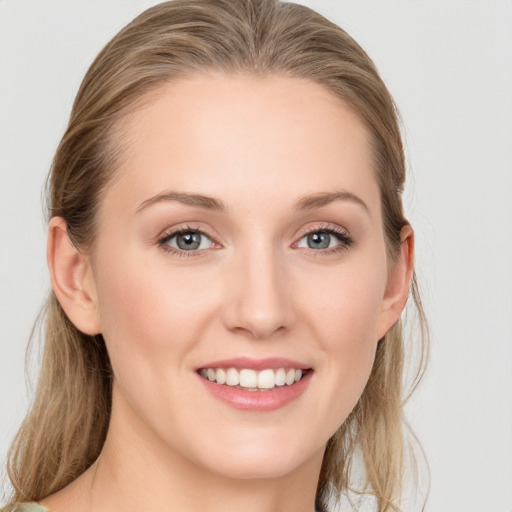 Joyful white young-adult female with medium  brown hair and blue eyes