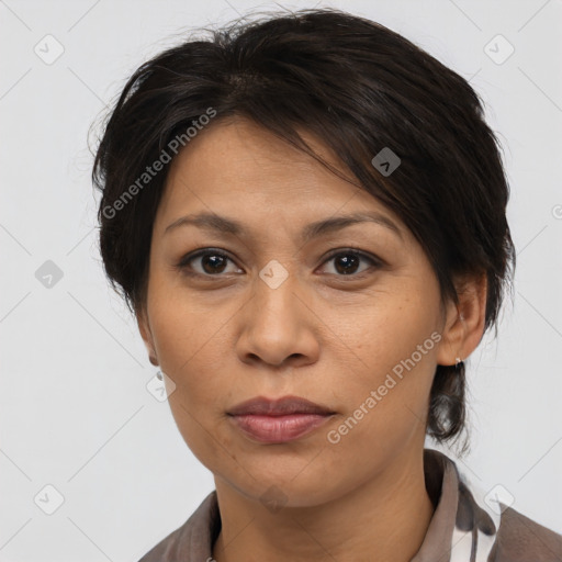 Joyful asian adult female with medium  brown hair and brown eyes